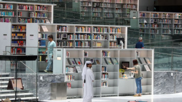 People walk through the aisles of the Qatar National Library in the capital Doha