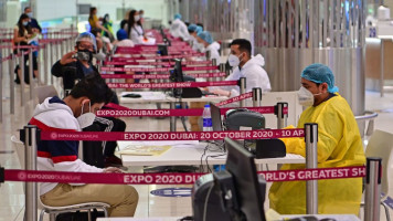 Tourists get their papers processed upon arrival at Teminal 3 at Dubai airport, in the United Arab Emirates [Getty Images]
