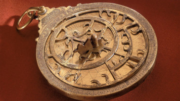 This brass Islamic astrolabe was made by Musatafa Ayyub-I in the Middle East. An astrolabe is in essence a model of the universe that an astronomer could hold in their hands