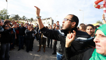 Supporters of Essebsi protest as Marzouki votes [Anadolu]