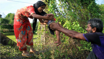 Rohingya passing baby AFP