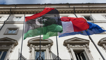 Libyan, Italian and European flags  -- Getty