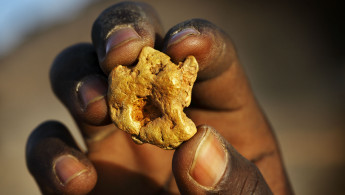 Gold miner holding gold nugget
