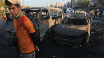 Iraq youth burned car (AFP)