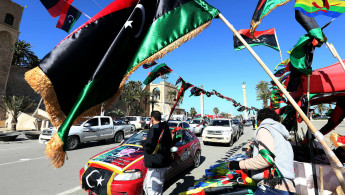 Libyan street vendor sells national flags 