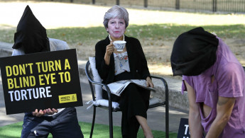 Amnesty protesters Theresa May torture Getty