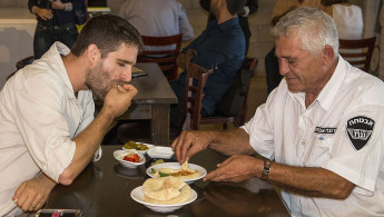 Israelis eating hummus [AFP]
