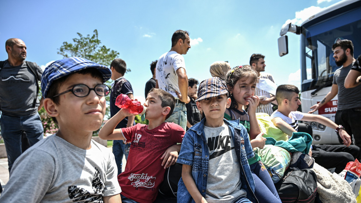 A group of Syrian children wait to board buses returning them to neighbouring Syria in Istanbul on 6 August 2019. [Getty]