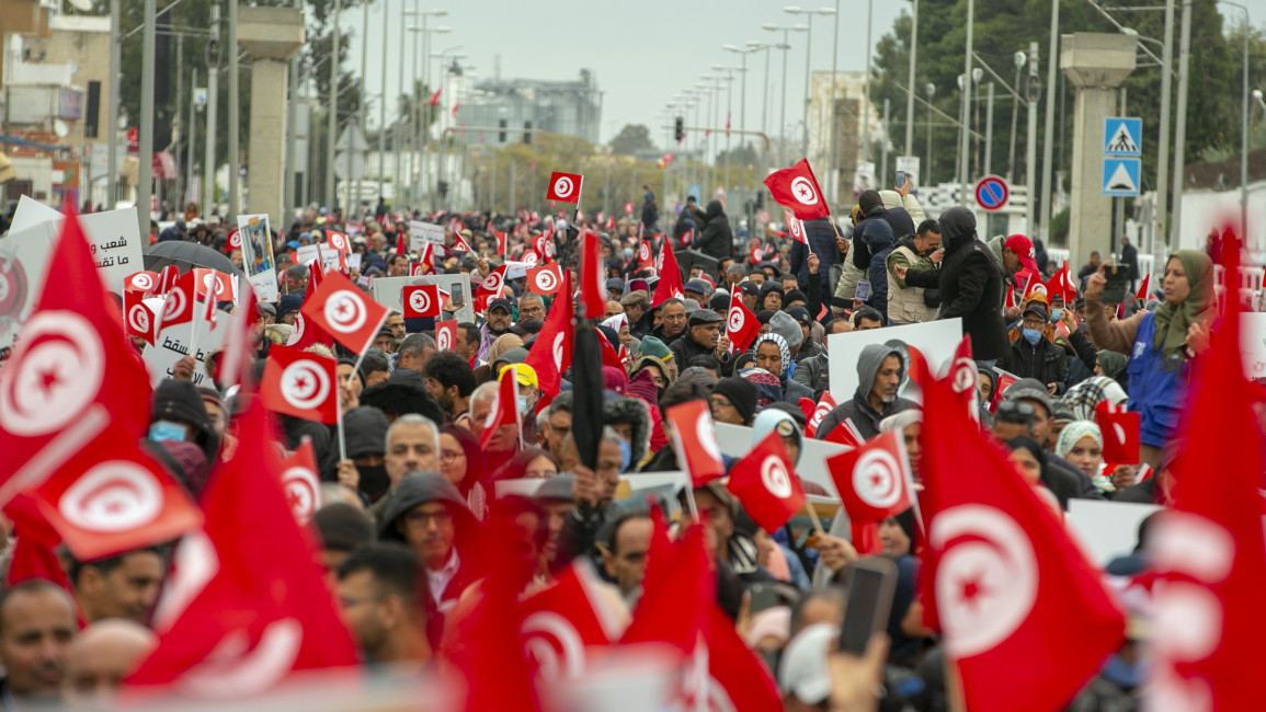 Tunisians protest against President Kais Saied's seizure of governing powers near the parliamentary headquarters in Tunis on March 20, 2022. [Getty]