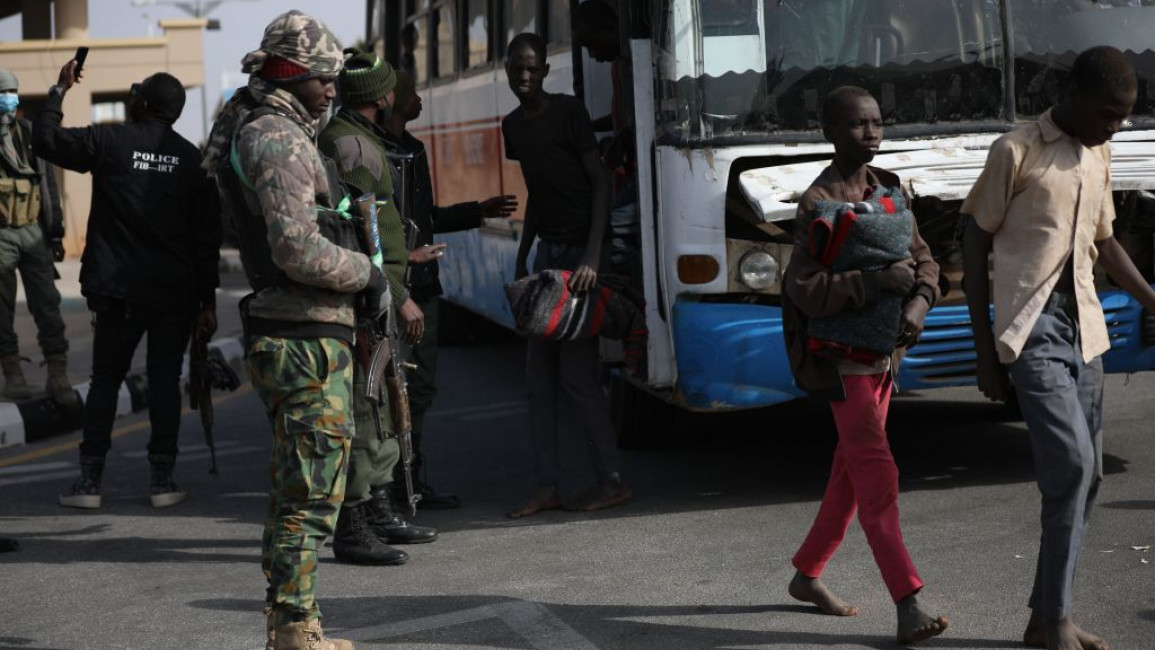 Students getting off a bus after being released from their capture by Boko Haram