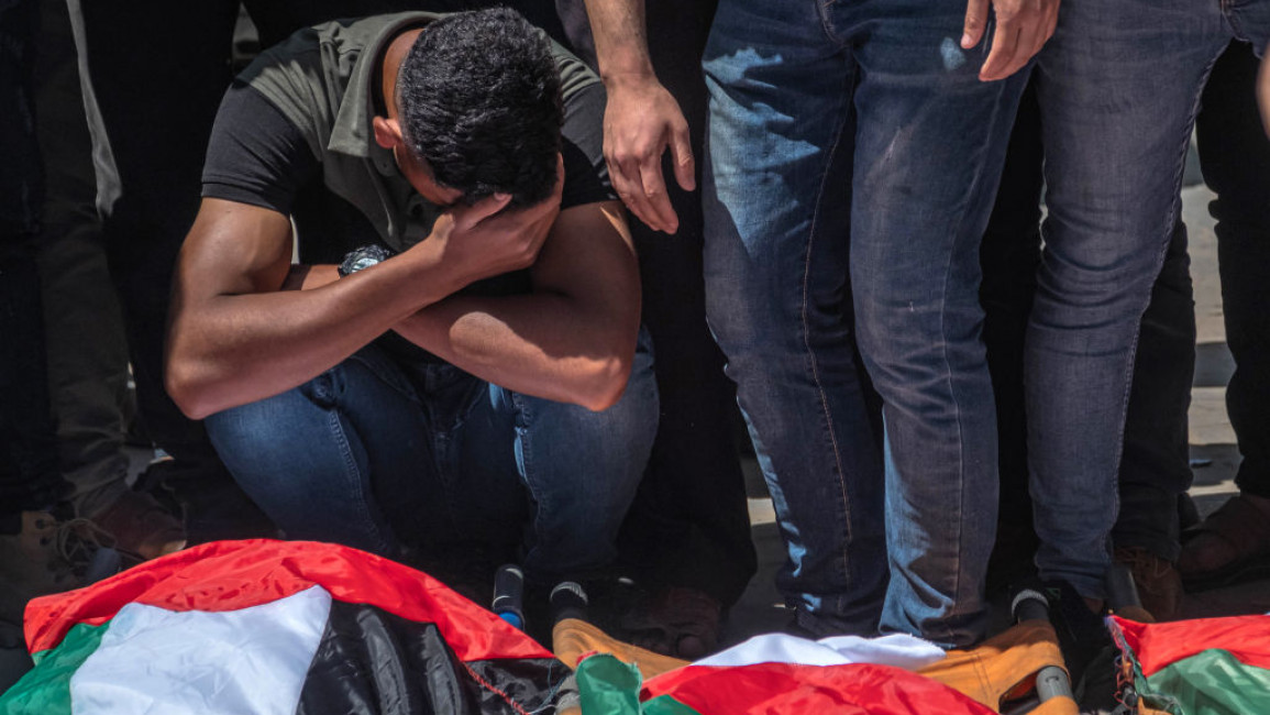 Palestinians take part in the funeral of the Abu Hatab family in Gaza 