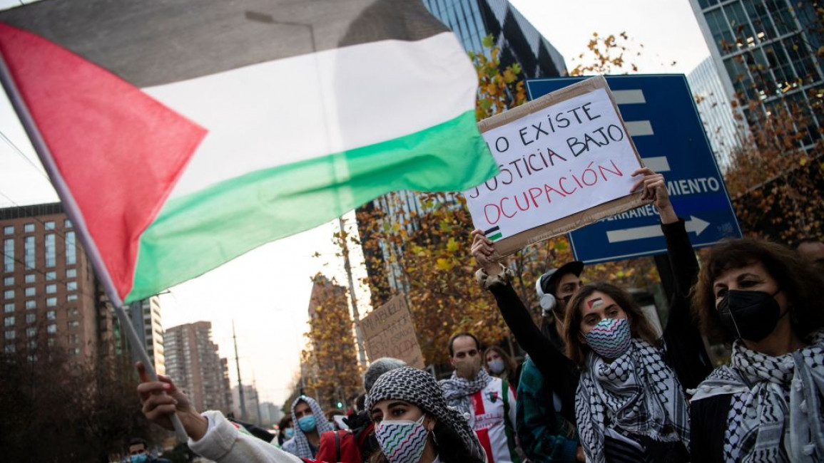 Protesters waved Palestinian flags outside the Israeli embassy in Chile [AFP]