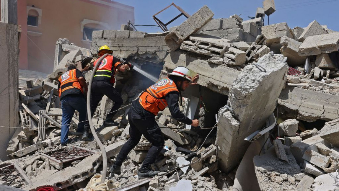A rescue team at a building after an Israeli airstrike in Gaza's Rafah City