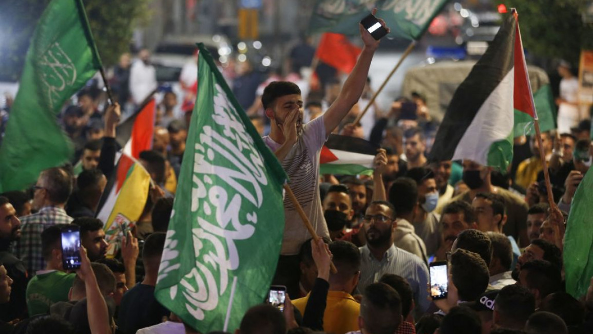Palestinians celebrate in support of a cease-fire between Hamas and Israel, in the early hours of May 21, 2021, in Ramallah, in the Israeli-occupied West Bank.