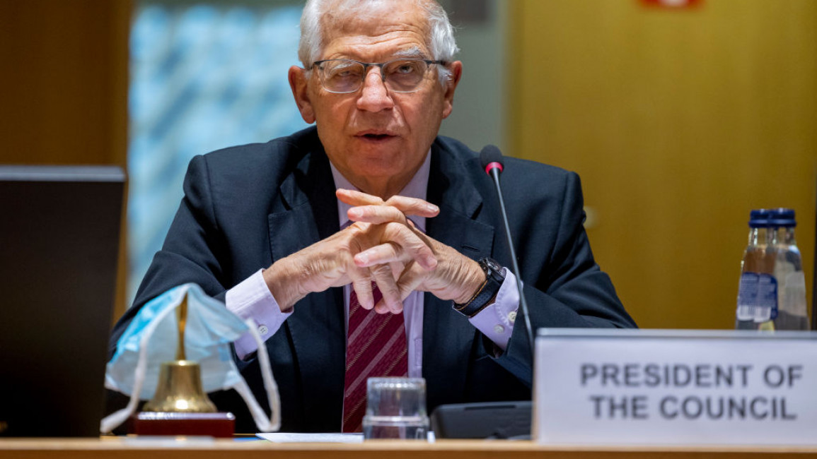 The EU's Josep Borrell sitting in front of a sign saying "President of the Council"