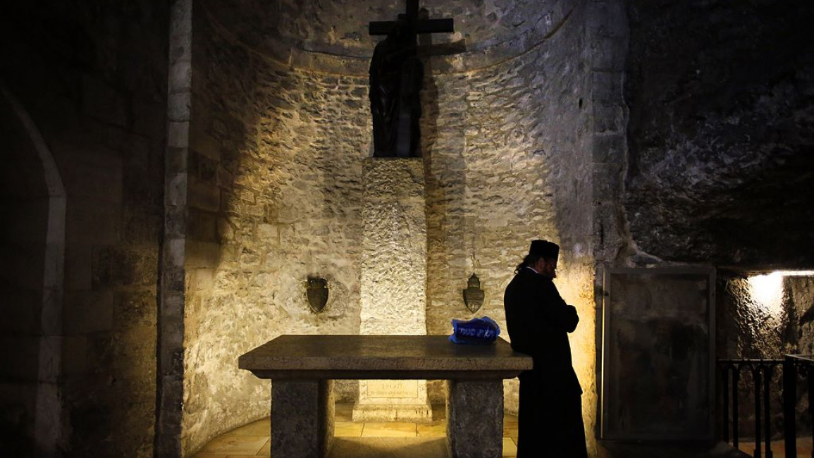 An Armenian priest prays inside the Armenian Chapel of Saint Helena, Jerusalem [Getty]