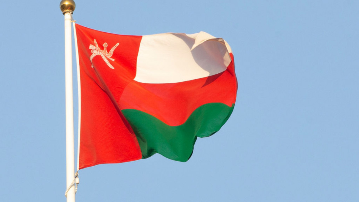 An Omani flag flying on a flagpole