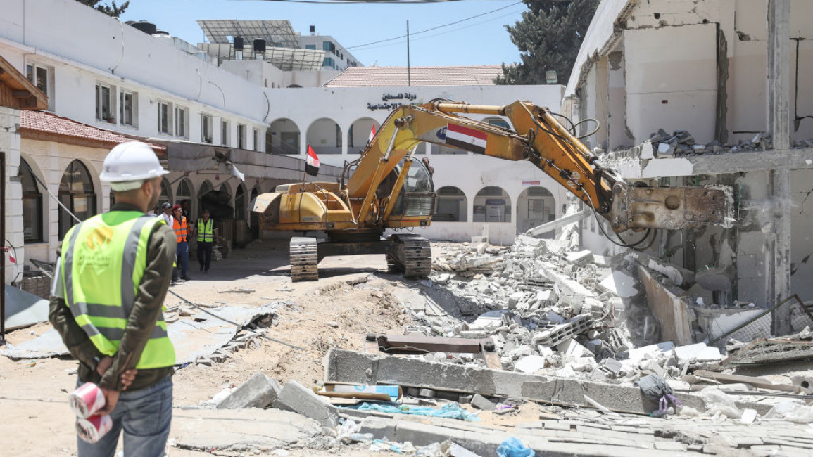 GAZA CITY, GAZA - JUNE 05: Egyptian technical teams to work in the debris removal and reconstruction works on a street after necessary equipment sent by Egypt reached Gaza City