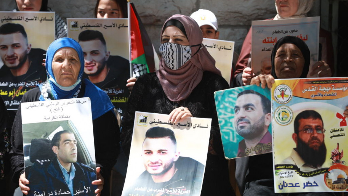 Ghadanfar Abu Atwan (in centre poster) has been held by Israel without trial since last October [Getty]