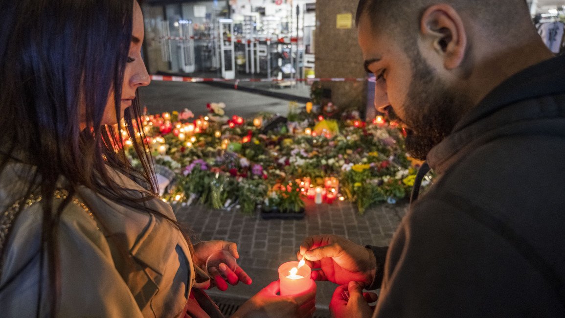 People lay flowers and candles near the site of a fatal attack by a knife-wielding man [Getty]
