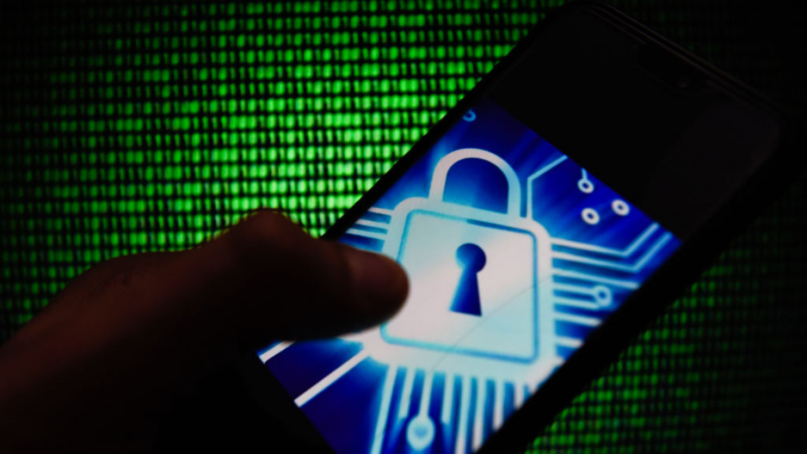 POLAND - 2019/02/17: In this photo illustration, the CYber lock symbol is seen displayed on an Android mobile phone with hacker code in the background. (Photo Illustration by Omar Marques/SOPA Images/LightRocket via Getty Images)