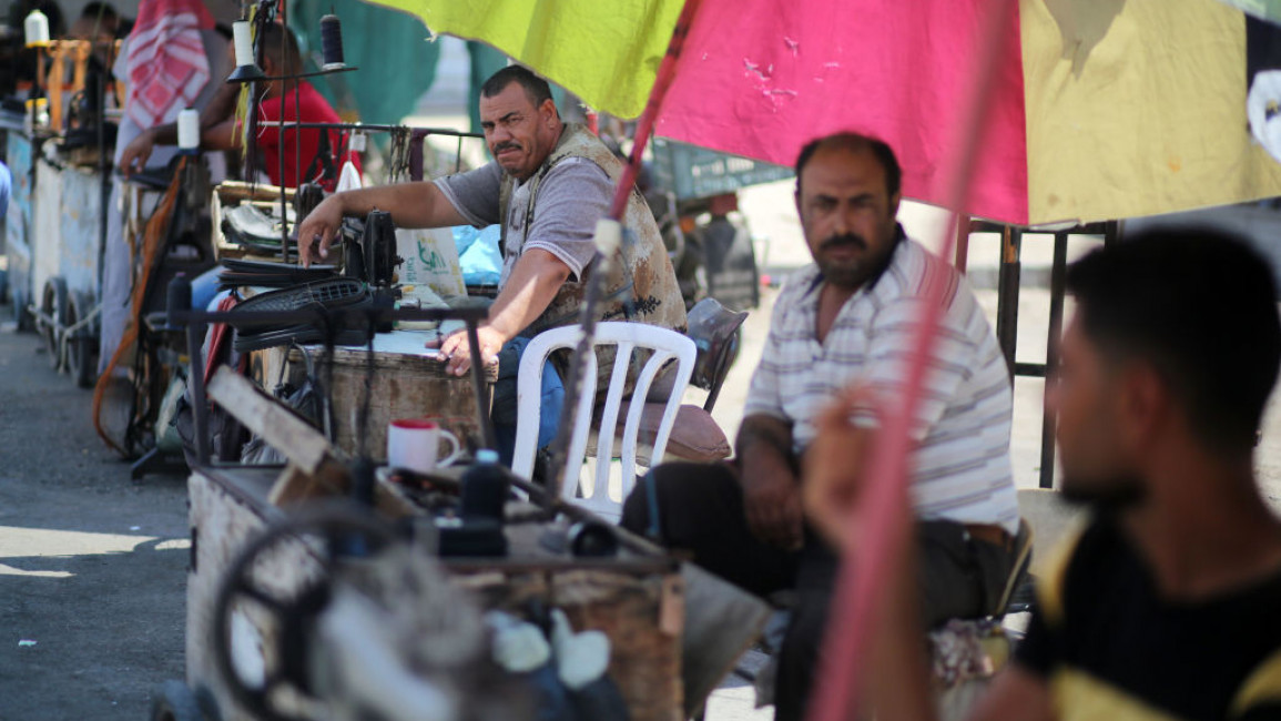 A Palestinian tailor rests at the market in Khan Yunis in the southern Gaza strip on July 27, 2019. (Photo by Majdi Fathi/NurPhoto via Getty Images)