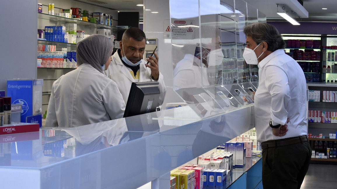 Pharmaceutists are seen at a pharmacy as people have difficulty in finding medicine in pharmacies [Getty]