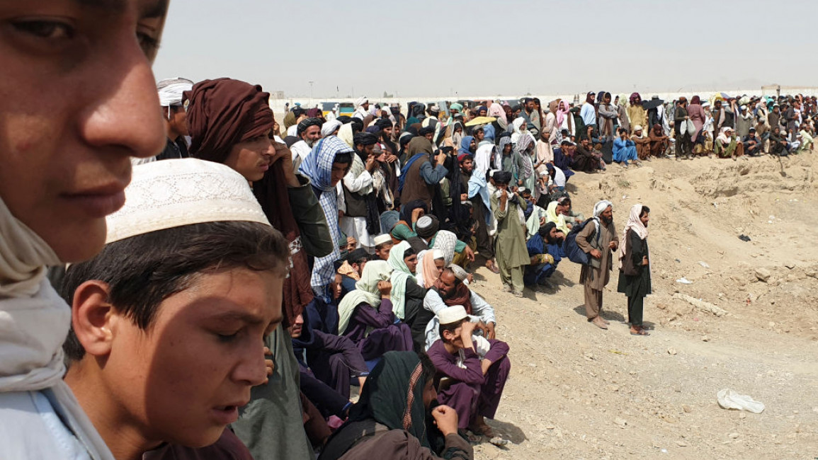 Hundreds of people tried to cross into Pakistan from the Afghan side of the border [AFP]