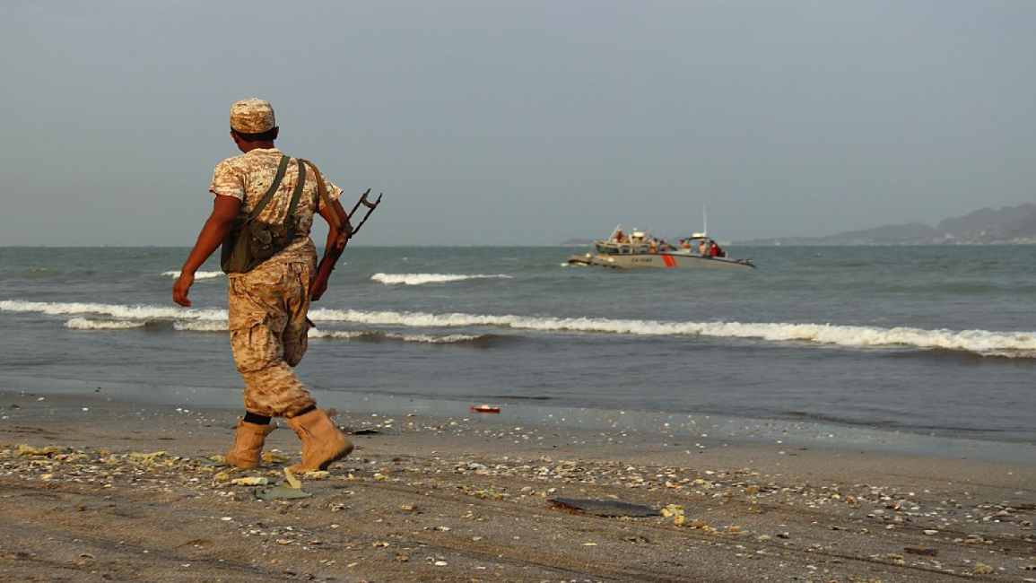 Pro-gvmnt Yemeni soldier walks along Aden coast