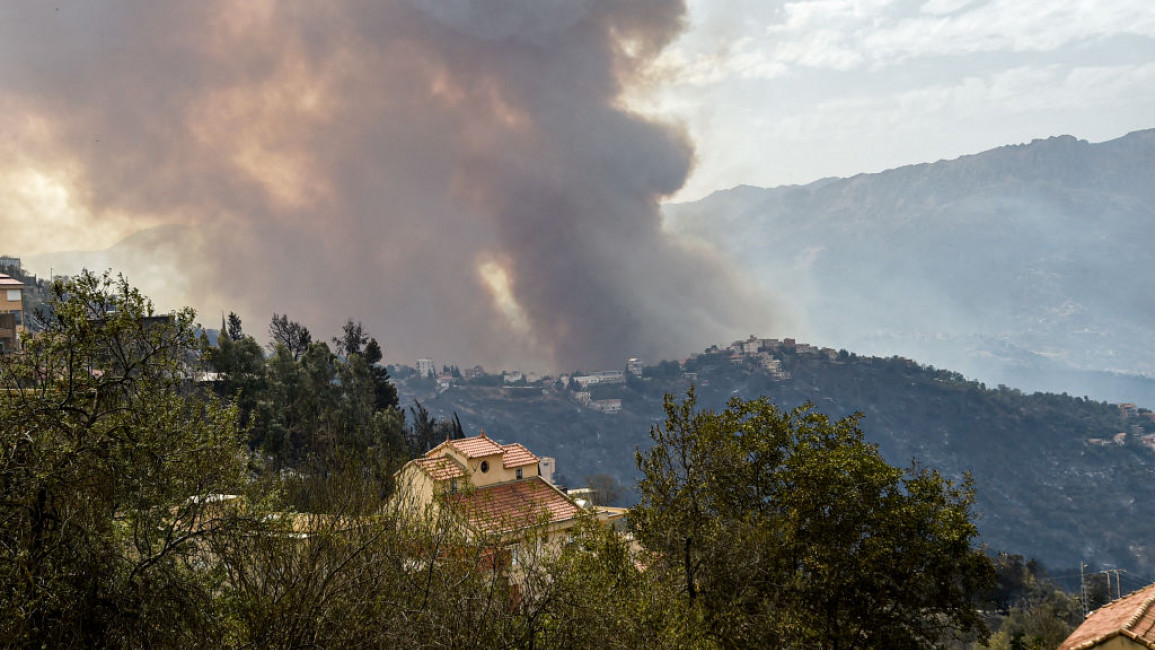 Smoke rises from a wildfire in the forested hills of the Kabylie region, east of the capital Algiers, on August 10, 2021.
