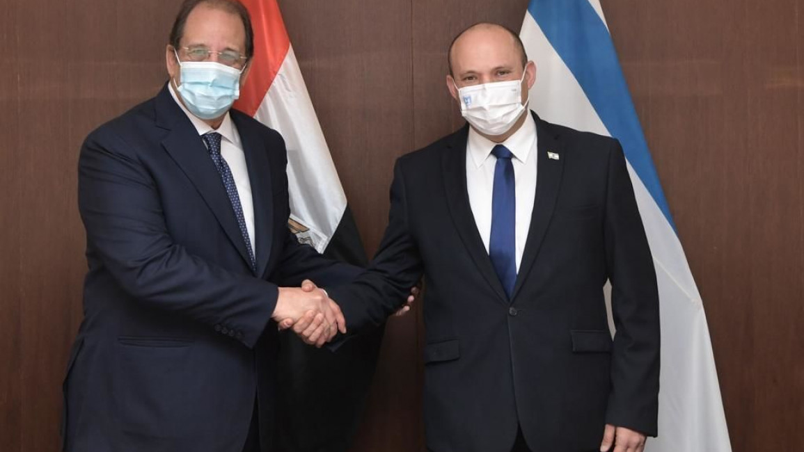Prime Minister of Israel Naftali Bennett (R) receives the Director of the Egyptian General Intelligence Directorate Abbas Kamel (L) during an official meeting in Jerusalem on August 18, 2021