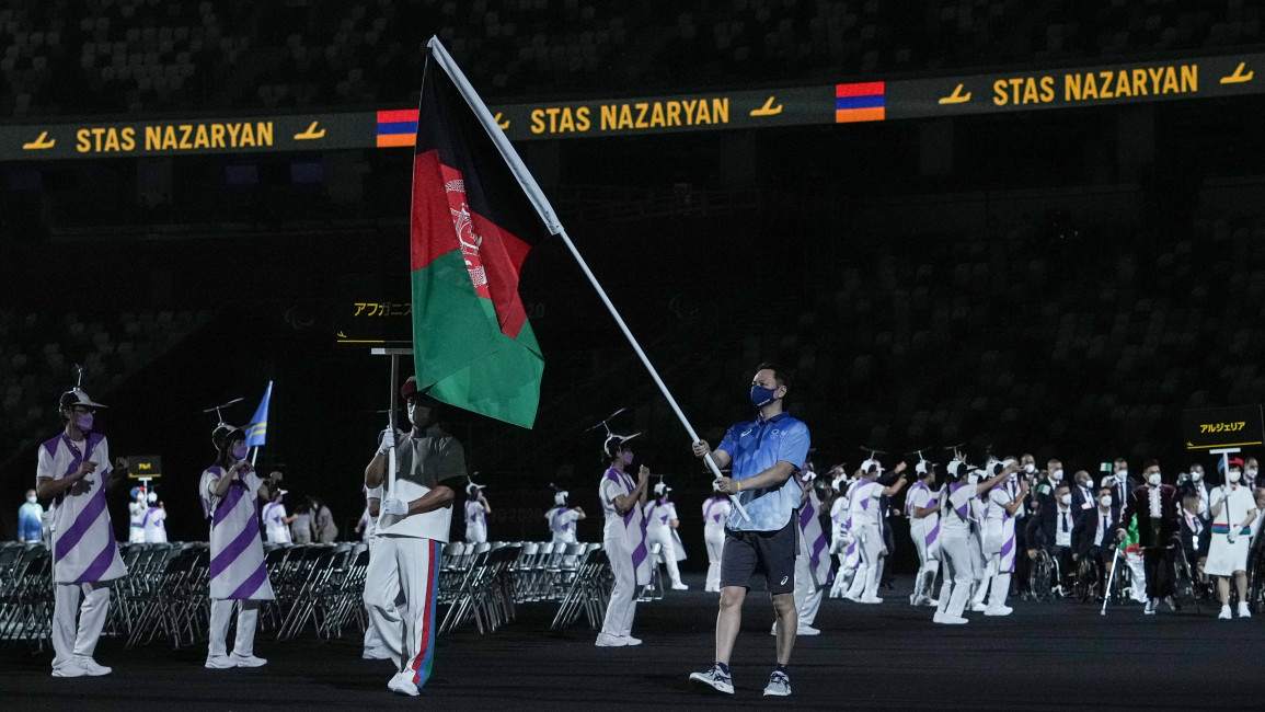 The flag of Afghanistan was brought out in solidarity to the athletes who couldn't attend the games [Getty]