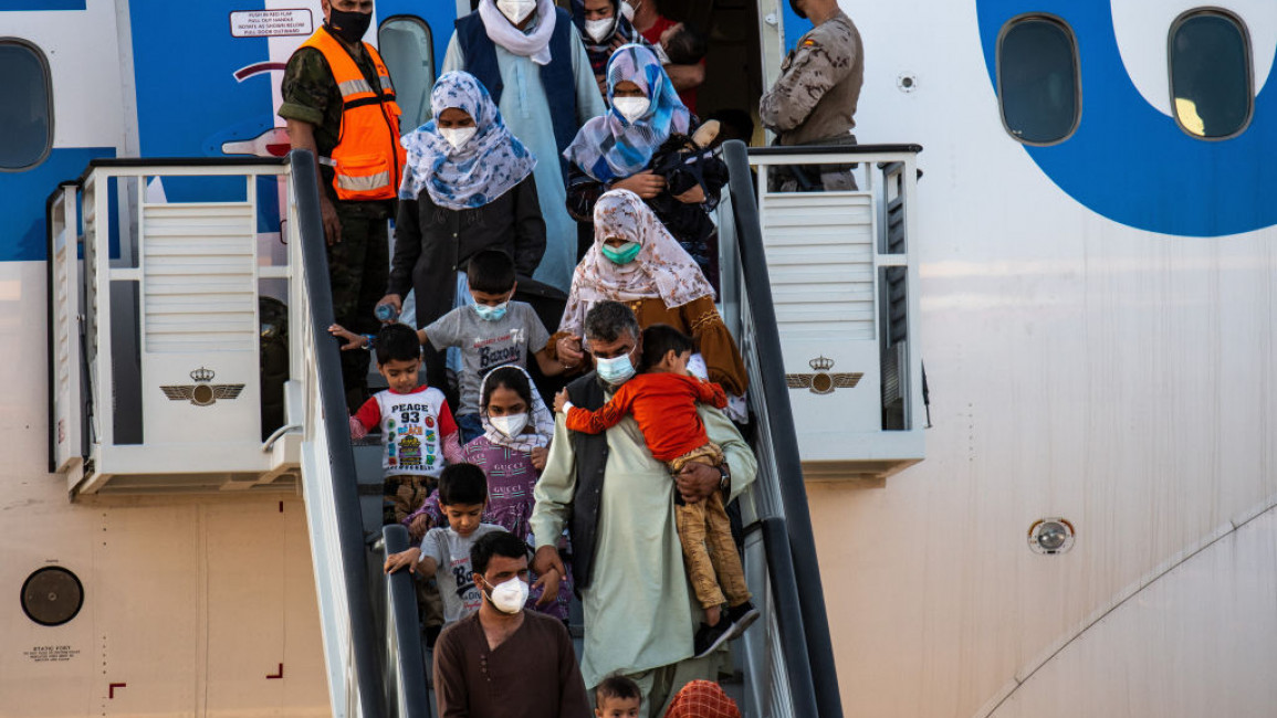Afghan people disembarking in Spain the last plane with evacuees - Getty