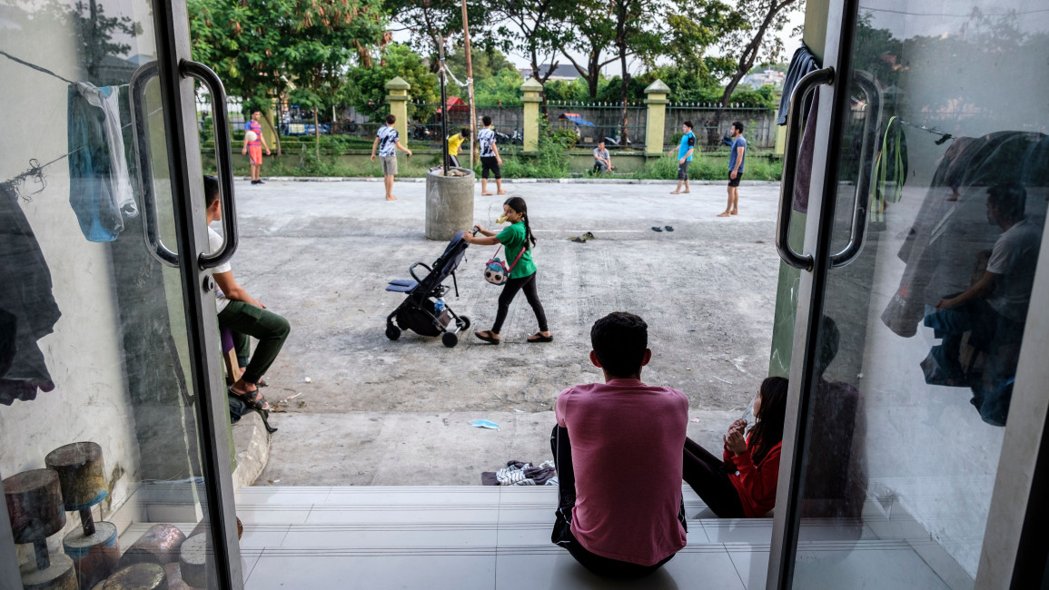 Afghan refugees pass the time in an Indonesian government facility set up for the refugees [Getty]