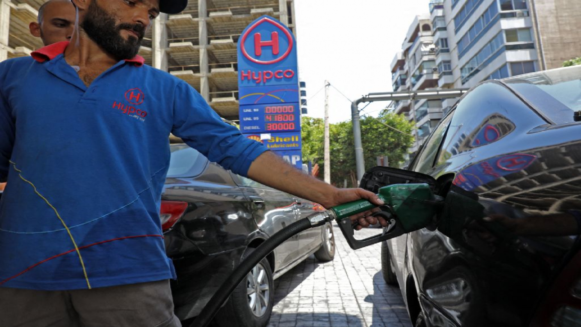 An employee fills up car at a petrol station in Beirut