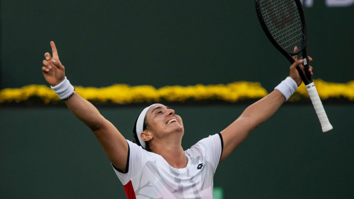 Ons Jabeur of Tunisia celebrates her victory over Anett Kontaveit of Estonia in the quarter finals of the BNP Paribas Open at the Indian Wells Tennis Garden on October 14, 2021