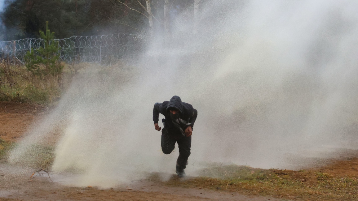 Polish law enforcement officers use water cannons against migrants [Getty]