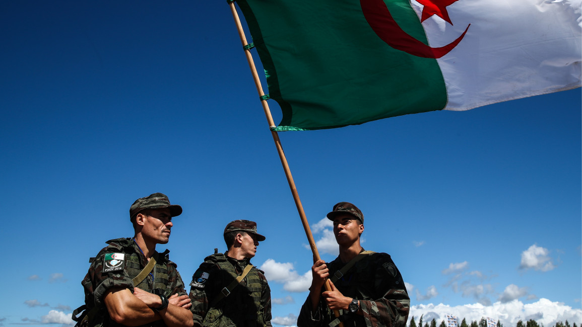 Participants from Algeria with a national Algerian flag during a relay race incorporating an obstacle course for air assault units with small arms during the Airborne Platoon contest at the 2018 International Army Games. Valery Sharifulin/TASS (Photo by Valery Sharifulin\TASS via Getty Images)