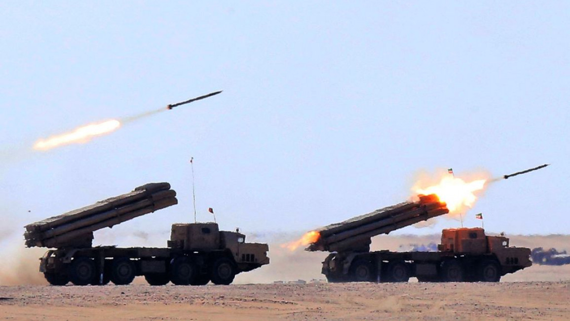 Two military trucks fire missiles