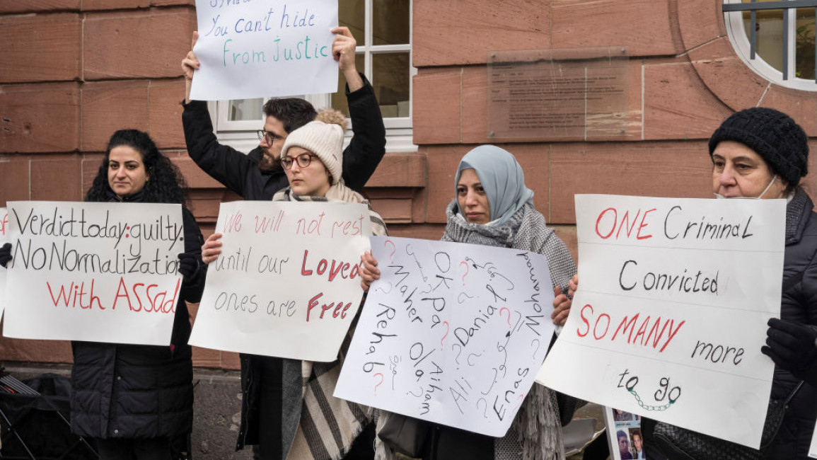 Syrians protested outside the court in Germany where Anwar Raslan was convicted [Getty]