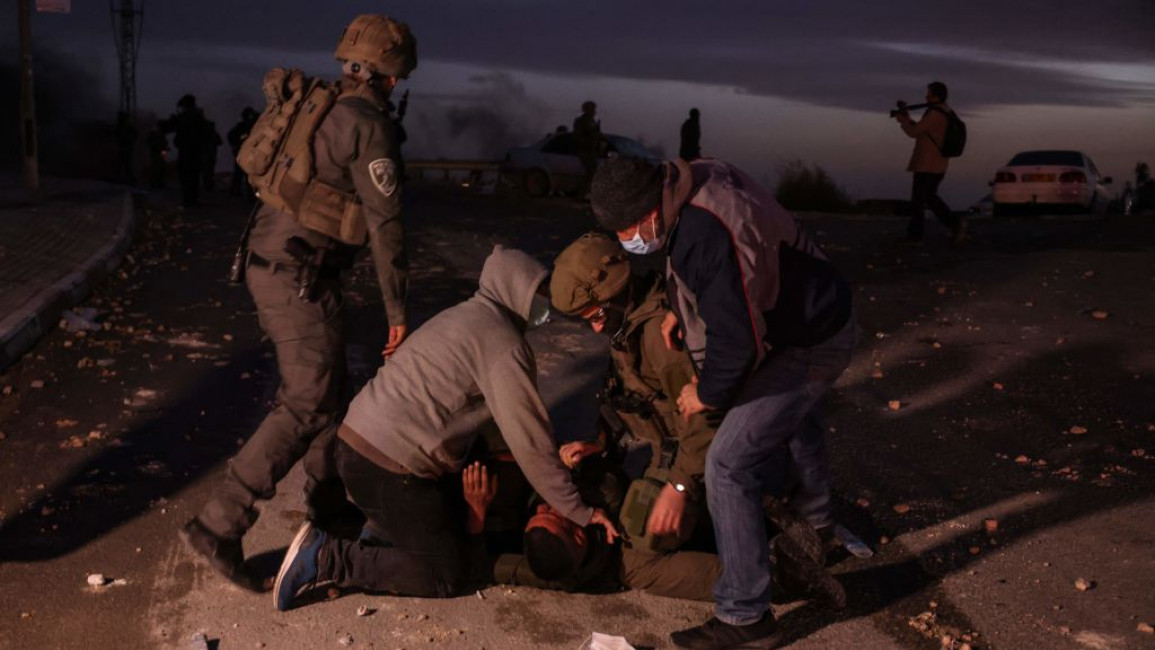 Israeli uniformed and undercover security arresting a Palestinian man in the Naqab