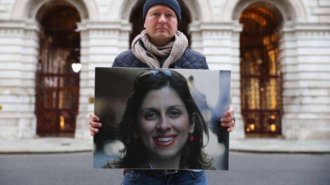 Nazanin Zaghari-Ratcliffe's husband holding a large photo of her