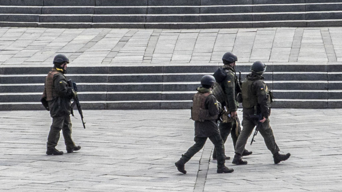 Ukrainian servicemen patrol during a curfew