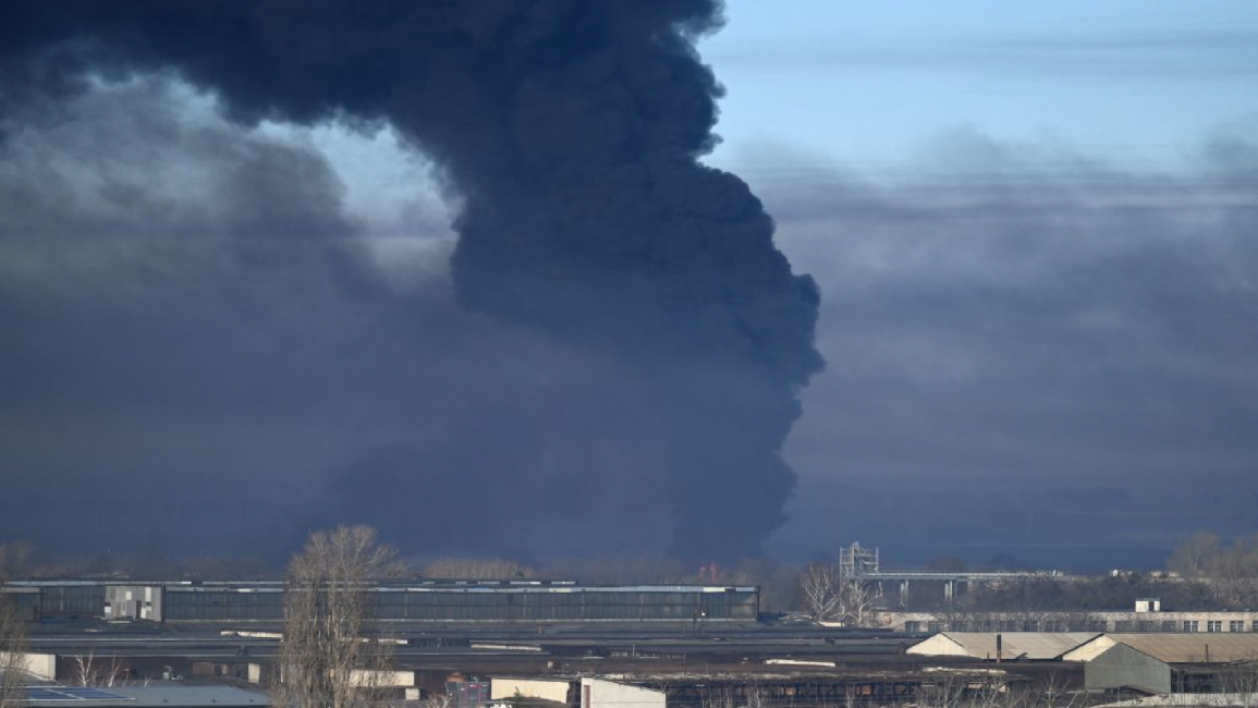 Black smoke rises from a military airport in Chuguyev, Ukraine, after Russia invasion