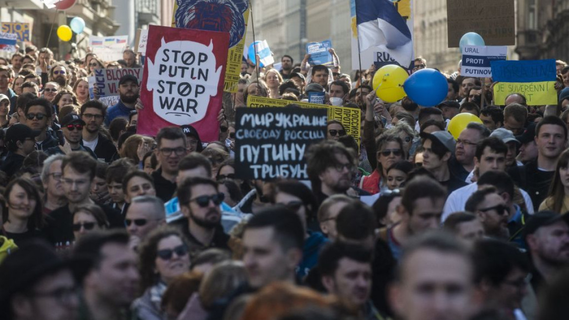 Members of Prague's Russian community holding placards take part in an anti-war demonstration