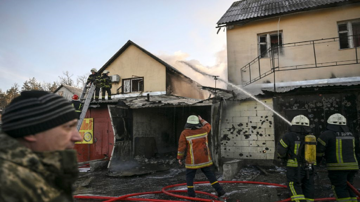 Firefighters extinguish a fire on a house in Mariupol, Ukraine