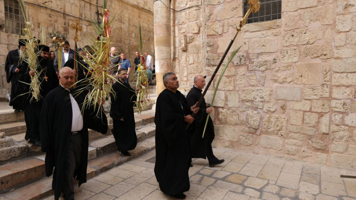 Orthodox Christian clergy take part in the Palm Sunday prosession at the church of Holy Sepulchre, in Jerusalem' Old City, on April 17,