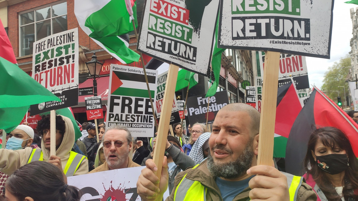 Pro-Palestine protesters holding placards with messages such as, "Free Palestine; end Israeli occupation."