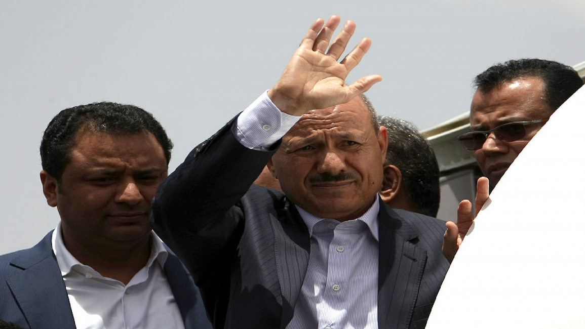 Rashad al-Alimi waves as he arrives at Sanaa airport in 2012