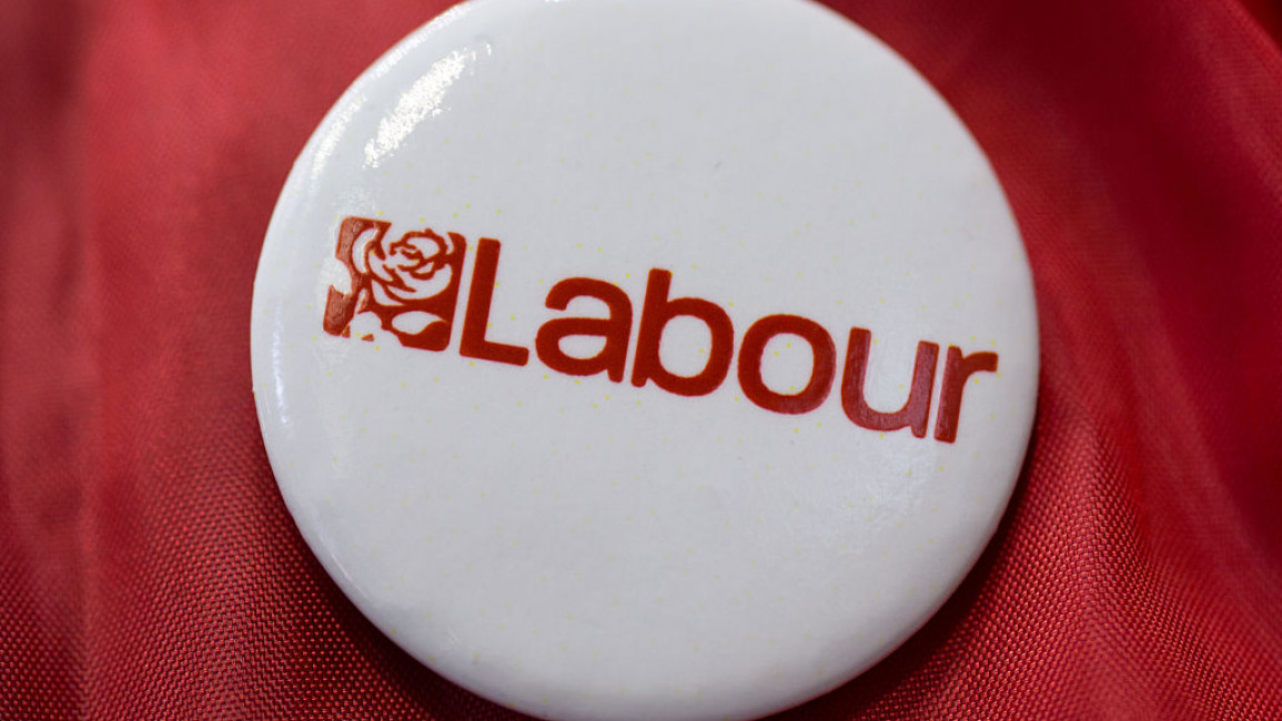 A circular badge reading, "Labour" and with the UK Labour Party's logo on.